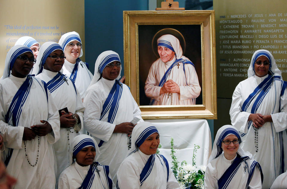 Members of Mother Teresa’s order gather around the official canonization portrait of Mother Teresa