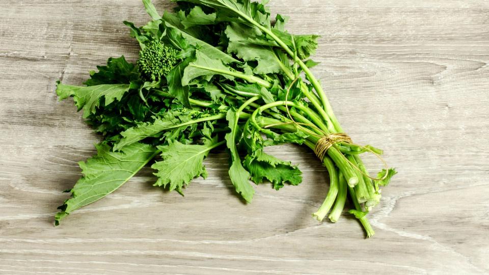 broccoli rabe over wooden surface