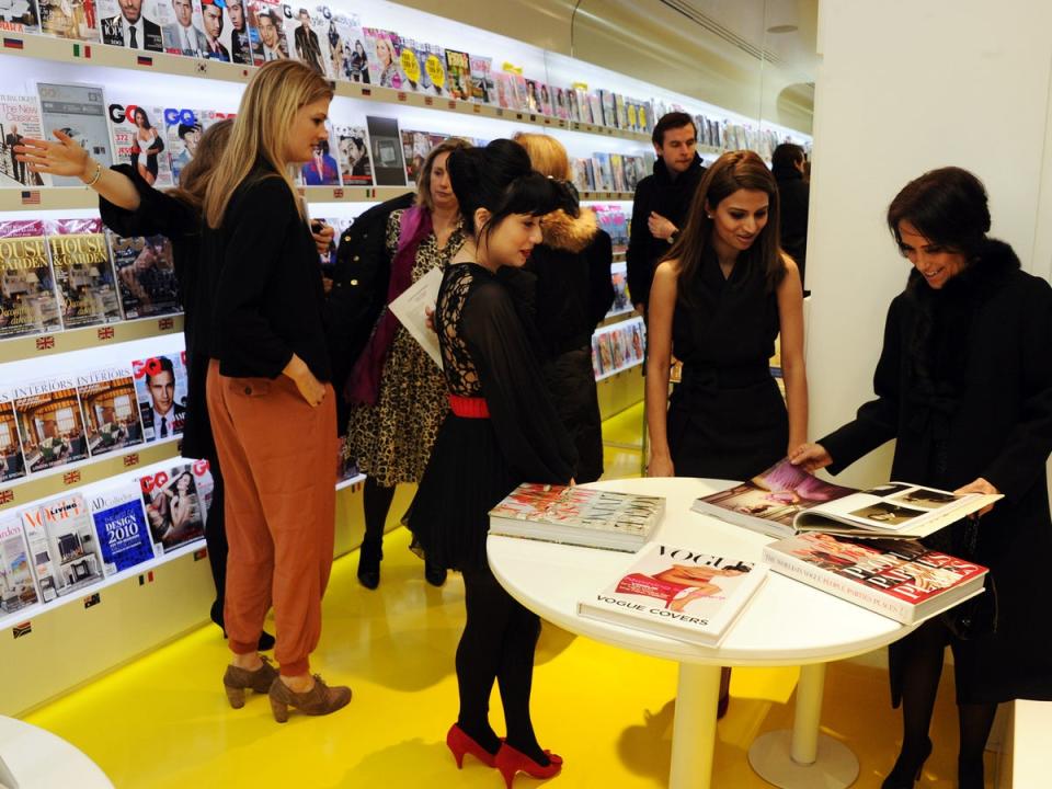 Vogue House employees mingle among the magazines in 2011 (Getty)