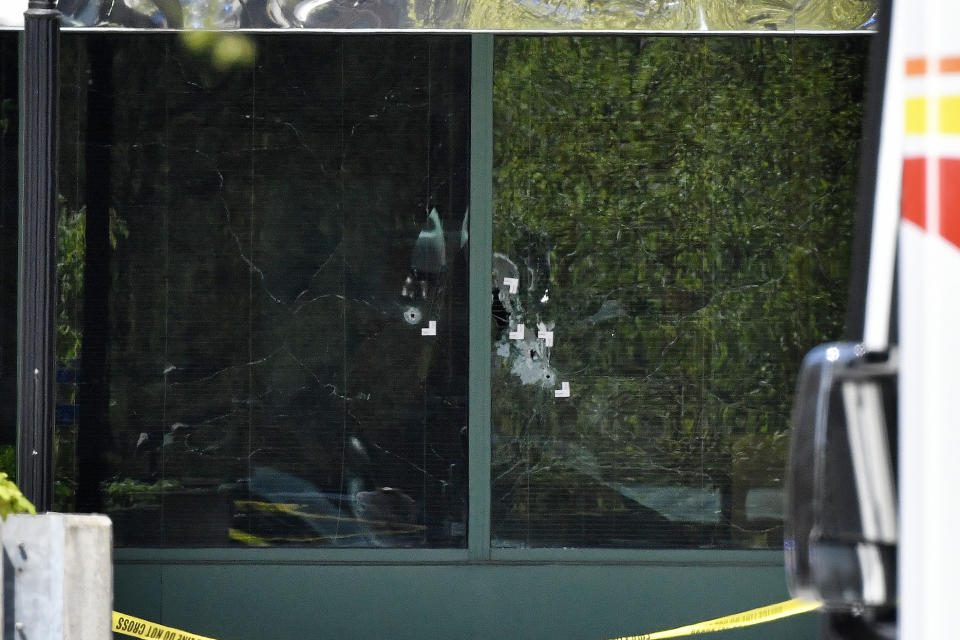 Bullet holes are seen in the front windows of the Old National Bank building in Louisville, Ky., Monday, April 10, 2023. A shooting at the bank killed and wounded several people police said. The suspected shooter was also dead. (AP Photo/Timothy D. Easley)