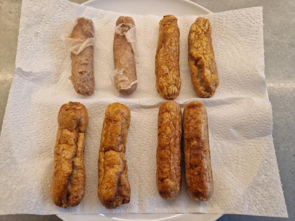 frozen sausages cooked in the microwave, air fryer, oven, and stove on a plate with a paper towel