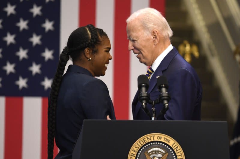 President Joe Biden (R) thanks student Sade Davis for her welcoming remarks, as he arrives to make remarks on Bidenomics, a major address on the difference between his programs and those of Republicans. Photo by Mike Theiler/UPI