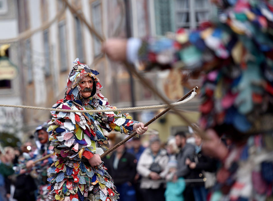 <p>A so-called “Peitschenschwinger” (whip cracker) carnival character parades through the streets of Mittenwald, southern Germany, as the hot carnival season starts on Women’s Carnival, Feb. 23, 2017.<br> (Photo: Angelika Warmuth/AFP/Getty Images) </p>