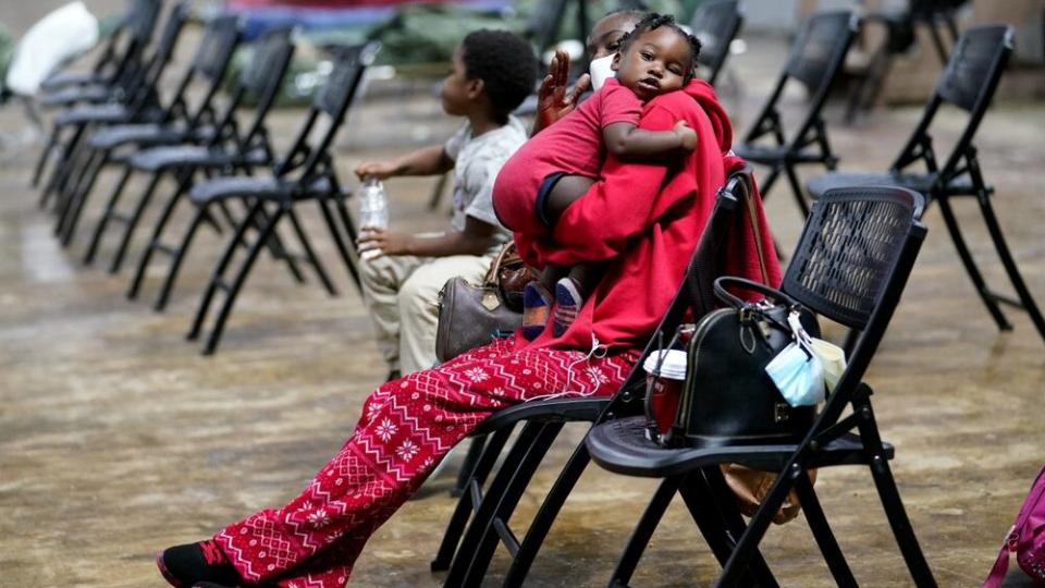 Roslyn Kennedy holds Malaka Kennedy, 1, in a shelter ahead of Hurricane Delta, Friday, Oct. 9, 2020, in Lake Charles, La. (AP Photo/Gerald Herbert)