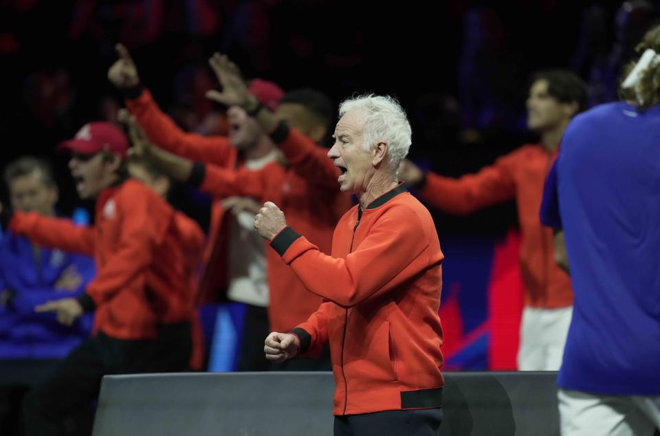 Team World's Captain John McEnroe cheers for teammate Frances Tiafoe during his singles tennis match against Team Europe's Stefanos Tsitsipas on the third day of the Laver Cup tennis tournament at the O2 arena in London, Sunday, Sept. 25, 2022. (AP Photo/Kin Cheung)