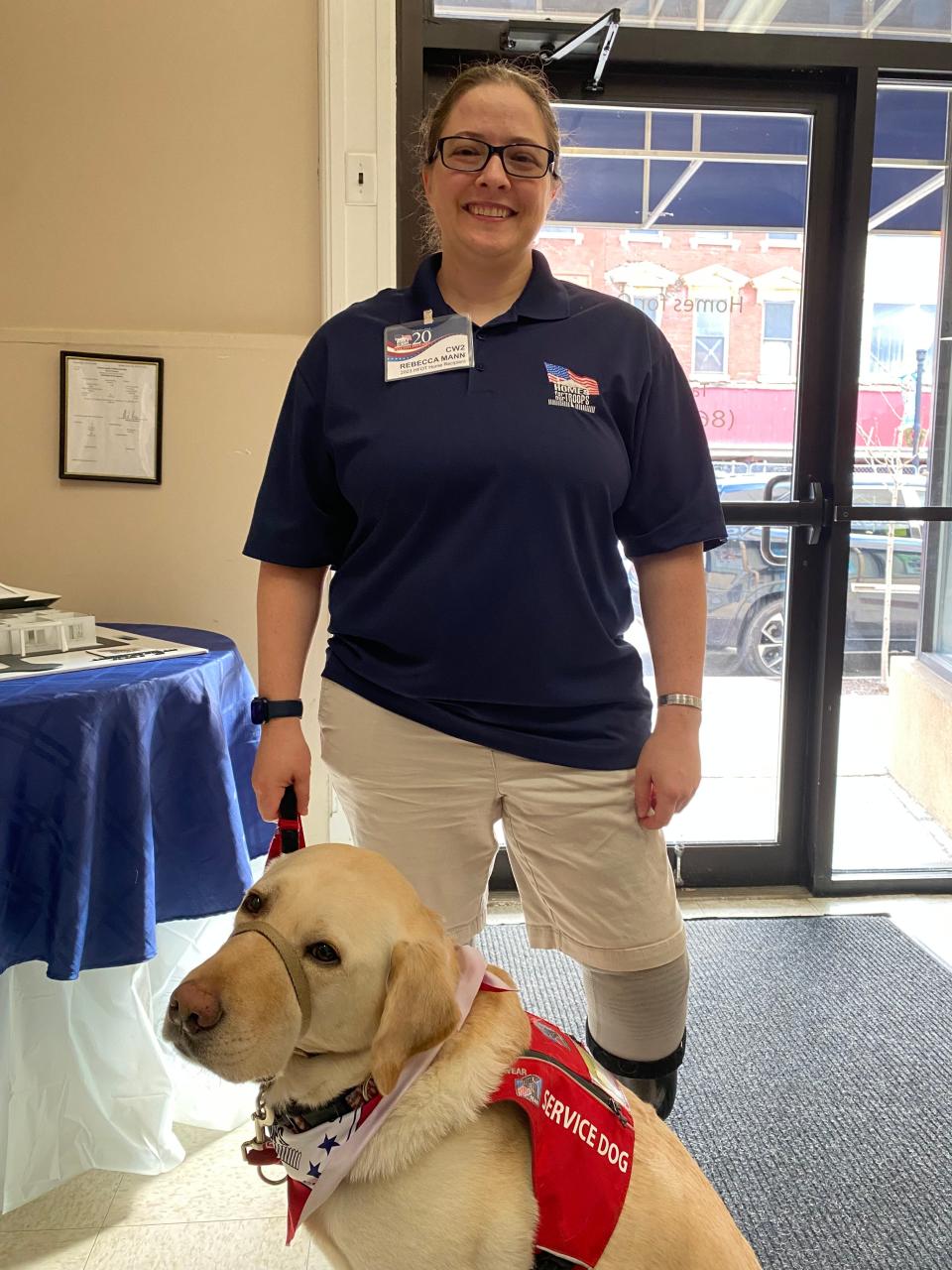 Homes for our Troops 2023 recipient Rebecca Mann of Mattapoisett, a U.S. Army veteran, and her service dog, Sully, attend the organization's 20-year anniversary celebration on Tuesday, Feb. 6, 2024 in downtown Taunton.