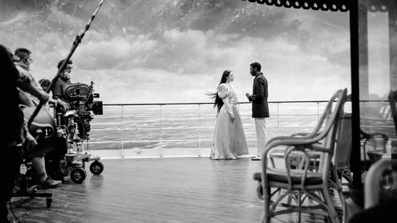  A scene from "Poor Things' in front of a VR set of an ocean on a cruise ship. . 