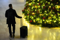 A traveler moves through 30th Street Station in Philadelphia, ahead of the Thanksgiving Day holiday, Wednesday, Nov. 22, 2023. (AP Photo/Matt Rourke)