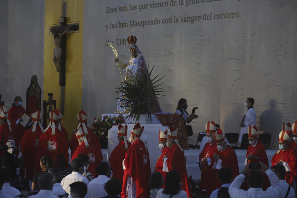 Catholic clergy walk to the main altar during a ceremony to beatify two priests, including Rev. Rutilio Grande and two lay people, all victims of right-wing death squads during El Salvador’s civil war, in San Salvador, Saturday, Jan. 22, 2022. The Rev. Rutilio Grande, a Jesuit priest killed alongside friends Manuel Solorzano and teenager Nelson Lemus on March 12, 1977, was known for his ministry to the poor and was an inspiration to St. Oscar Romero, the then-archbishop of El Salvador who himself was murdered three years later. (AP Photo/Salvador Melendez)