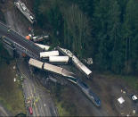 <p>This aerial image from video provided by KOMO-TV, shows the site of an Amtrak train that derailed south of Seattle on Monday, Dec. 18, 2017. Authorities reported “injuries and casualties.” The train derailed about 40 miles (64 kilometers) south of Seattle before 8 a.m., spilling at least one train car on to busy Interstate 5. (Photo: KOMO-TV via AP) </p>