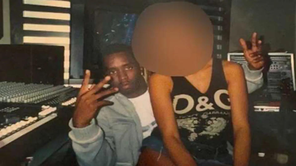 Sean Diddy Combs seated with the alleged Jane Doe in a studio photo from lawsuit. her face is blurred.