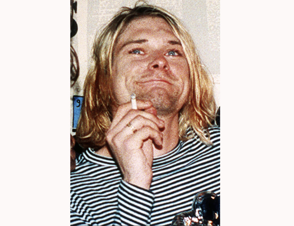 FILE - This 1993 file photo shows Kurt Cobain, the lead singer of the U.S. rock band Nirvana. Grunge became gold Saturday, June 20, 2020, as the guitar Cobain played on Nirvana's 1993 “MTV Unplugged” performance sold for an eye-popping $6 million at auction. (AP Photo/Mark J. Terrill, File)