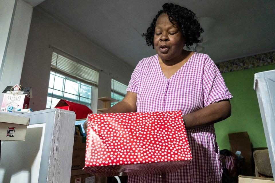 Sandra Stephenson wraps a Christmas present for a toy drive. Diabetes and kidney failure has meant that the lifelong caregiver is losing her vision. She was nominated for Season for Caring by Interfaith Action of Central Texas.
