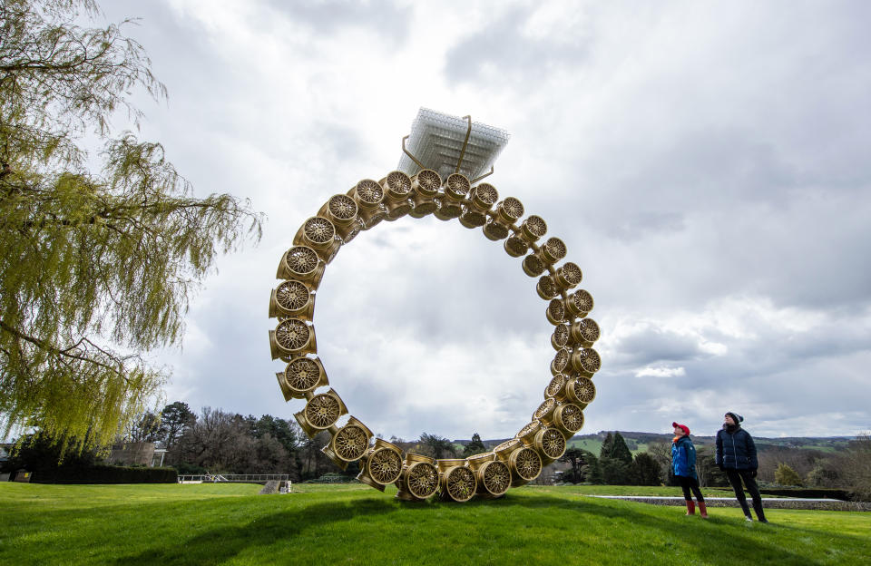 <p>Visitors Max Blyth (left) and Finton Blyth view a work titled 'Solitaire' by artist Joana Vasconcelos at the Yorkshire Sculpture Park (YSP). The grounds of the park are open and the YSP is looking forward to welcoming visitors back to other areas as soon as government restrictions allow. Picture date: Tuesday April 6, 2021. (Photo by Danny Lawson/PA Images via Getty Images)</p>
