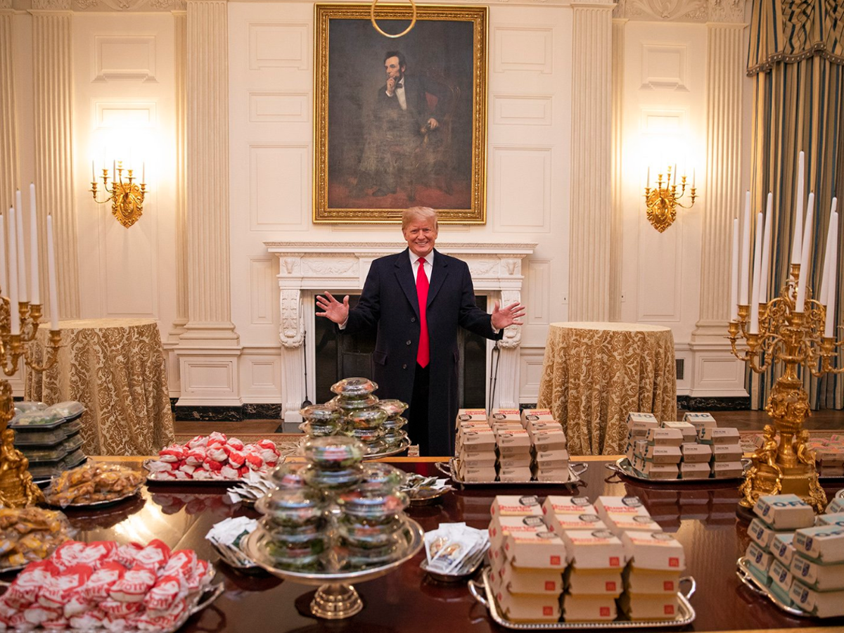 A delighted Donald Trump poses with his White House junk food buffet while president (White House)