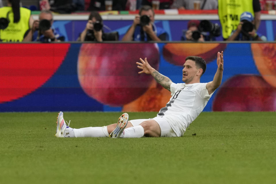 Slovenia's Erik Janza celebrates scoring his side's first goal during a Group C match between Slovenia and Denmark at the Euro 2024 soccer tournament in Stuttgart, Germany, Sunday, June 16, 2024. (AP Photo/Antonio Calanni)