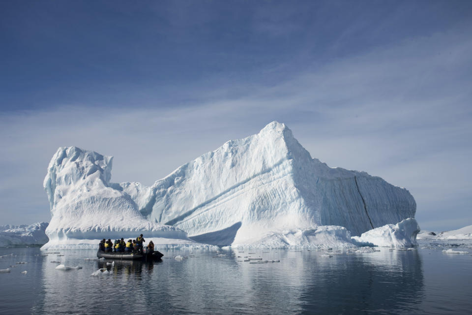 In this Dec. 1, 2009 photo provided by Aurora Expeditions, an inflatable boat carries tourists past an iceberg along the Antarctic Peninsula. In a remote, frozen, almost pristine land where the only human residents are involved in research, tourism comes with risks, for both the continent and the tourists. (AP Photo/Aurora Expeditions, Andrew Halsall) EDITORIAL USE ONLY