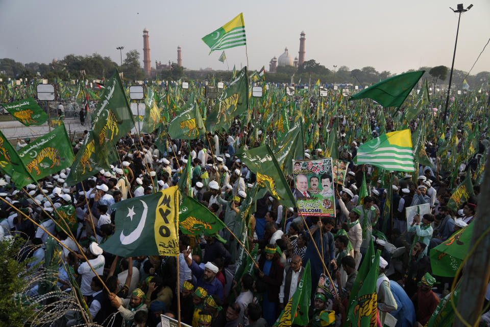 Supporters of Pakistan's former Prime Minister Nawaz Sharif attend a welcoming rally for their leader, in Lahore, Pakistan, Saturday, Oct. 21, 2023. Sharif returned home Saturday on a special flight from Dubai, ending four years of self-imposed exile in London as he seeks to win the support of voters ahead of parliamentary elections due in January. Sharif is expected to address a massive homecoming rally in the eastern city of Lahore on Saturday evening and his return comes as Pakistan is experiencing deepening political turmoil and one of its worst economic crises. (AP Photo/Anjum Naveed)