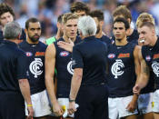 Mick Malthouse leads his charges in the first match between Carlton and Collingwood since he switched teams.