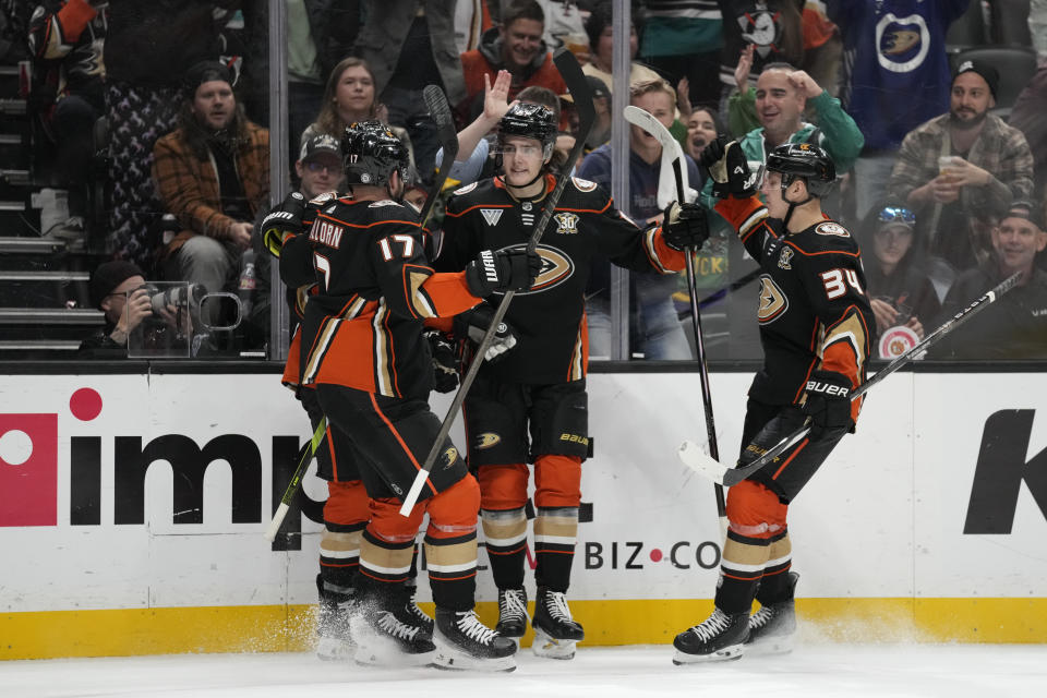 Anaheim Ducks center Leo Carlsson, center, celebrates with teammates after scoring during the third period of an NHL hockey game against the Philadelphia Flyers in Anaheim, Calif., Friday, Nov. 10, 2023. (AP Photo/Ashley Landis)