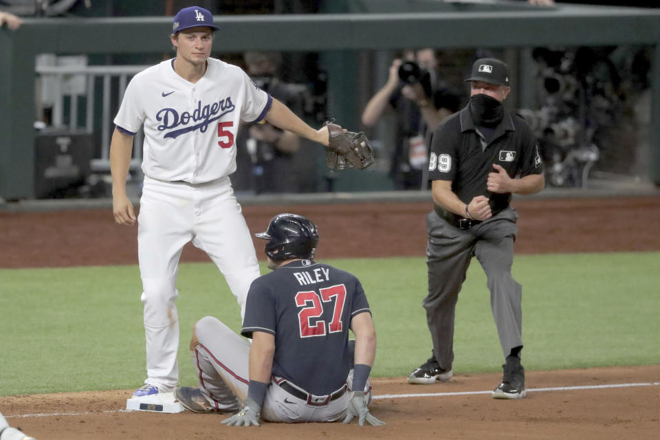 Atlanta Braves third baseman Austin Riley (27) is out at third base after the tag by Los Angeles Dodgers shortstop Corey Seager following a rundown of Atlanta Braves shortstop Dansby Swanson (not pictured) during the fourth inning in Game 7 Sunday, Oct. 18, 2020, in the best-of-seven National League Championship Series in Arlington, Texas. (Curtis Compton/Atlanta Journal-Constitution via AP)