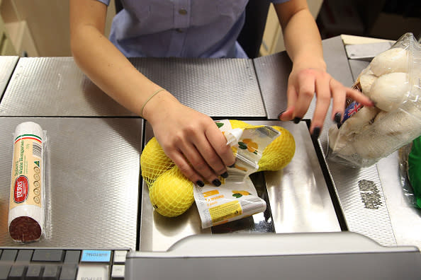 An employee scans a bag of lemons at the check-out counter of an Aldi Stores Ltd. food store in Sydney.