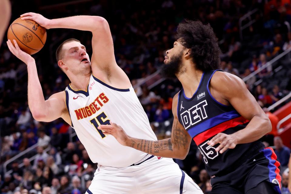 Nuggets center Nikola Jokic is defended by Pistons forward Marvin Bagley III in the first half of the Pistons' 107-103 loss on Monday, Nov. 20, 2023, at Little Caesars Arena.