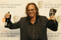 U.S. Actor Mickey Rourke poses after winning the award for Leading Actor for "The Wrestler" during the 2009 BAFTA (British Academy of Film and Television Arts) awards ceremony at the Royal Opera House in London February 8, 2009. REUTERS/Toby Melville (BRITAIN)