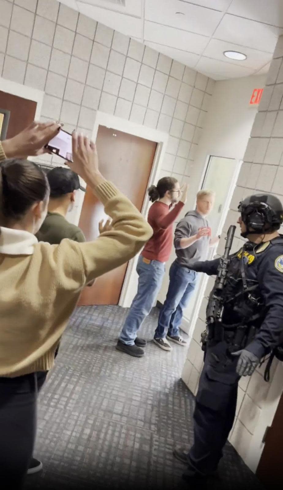 PHOTO: Students exit a building with their hands up after a shooting on the University of Nevada, Las Vegas campus, on Dec. 6, 2023, in Las Vegas. (Carlos Eduardo Espina)