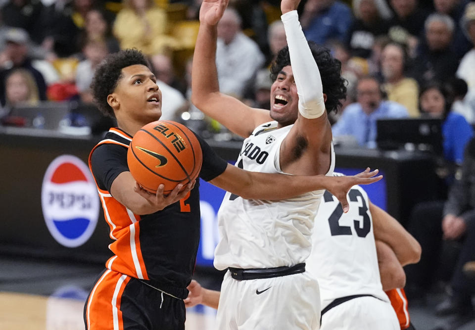 Oregon State guard Josiah Lake II, left, drives to the basket as Colorado guard Julian Hammond III, front right, defends in the first half of an NCAA college basketball game Saturday, Jan. 20, 2024, in Boulder, Colo. (AP Photo/David Zalubowski)