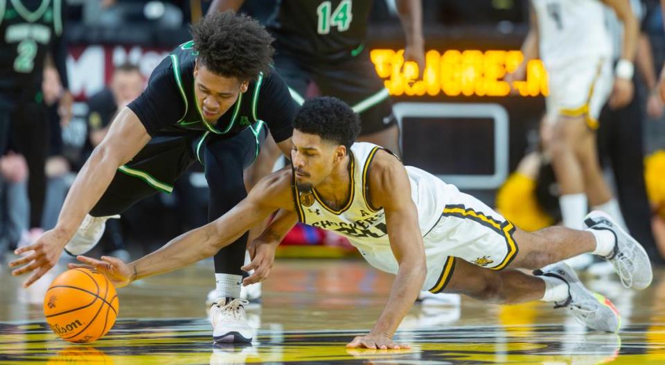 Harlond Beverly dives for a loose ball against North Texas’ CJ Noland during the first half of their game at Koch Arena on Thursday night. 