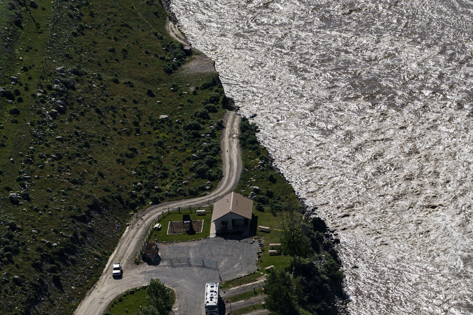 A road ends where floodwaters washed away a house in Gardiner, Mont., Thursday, June 16, 2022. Yellowstone officials are hopeful that next week they can reopen the southern half of the park, which includes Old Faithful geyser. Park officials say the northern half of the park, however, is likely to remain closed all summer, a devastating blow to the local economies that rely on tourism. (AP Photo/David Goldman)