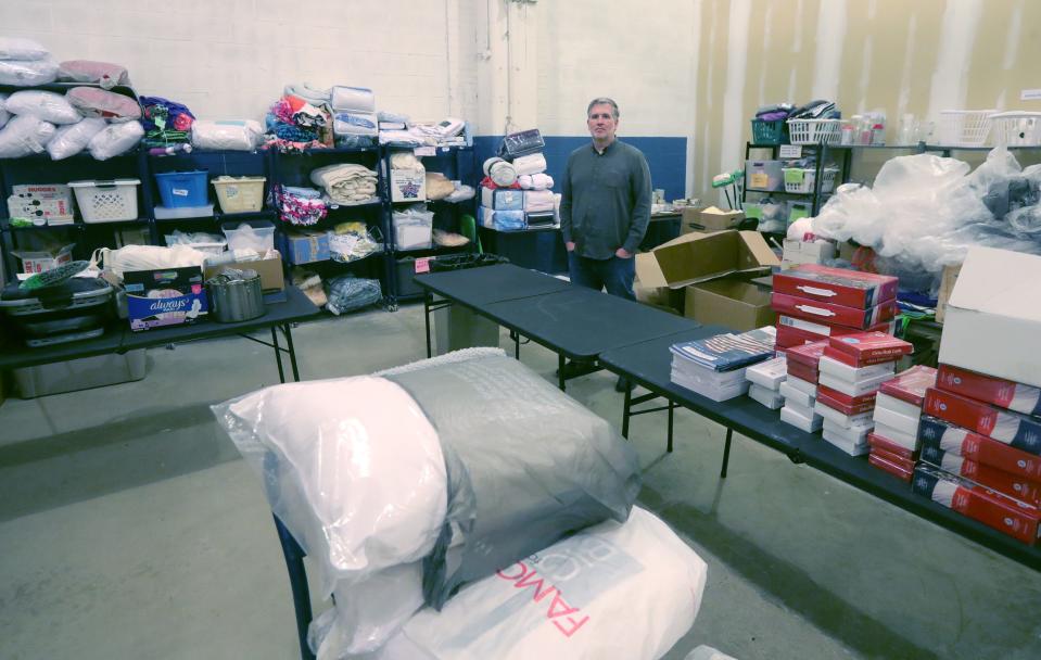 International Institute Advocacy and Outreach Coordinator Kevin Walter shows the organization's donation room at Canal Place in Akron.