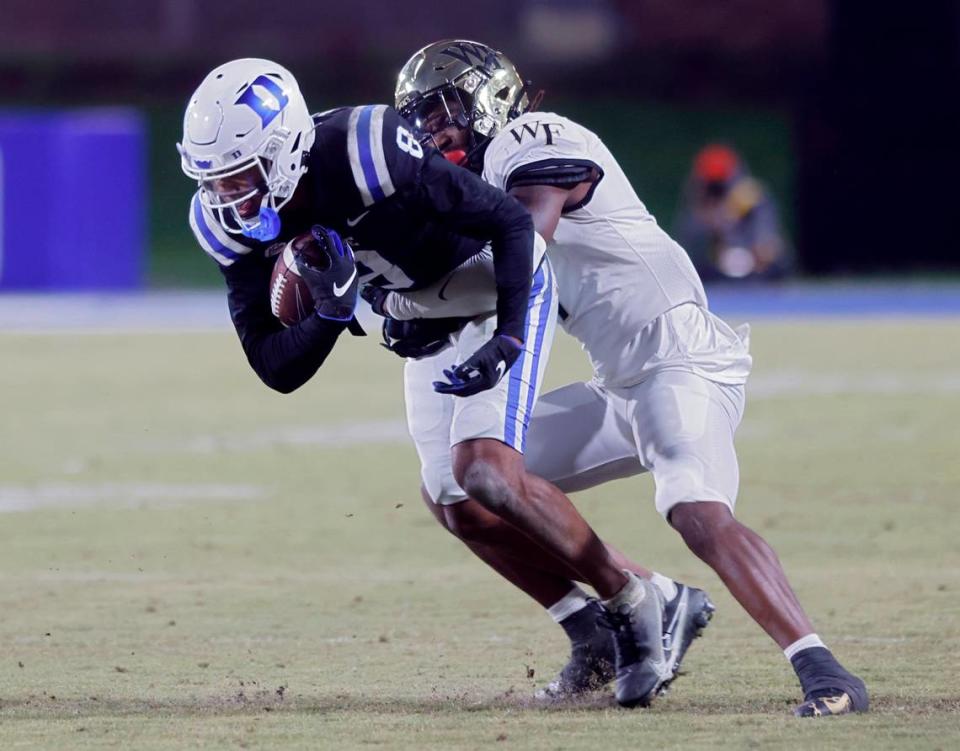 Duke’s Jordan Moore is brought down by Wake Forest’s Caelen Carson during the second half of the Blue Devils’ final regular season game at Wallace Wade Stadium on Saturday, Nov. 26, 2022, in Durham, N.C.