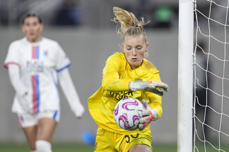 OL Reign goalkeeper Claudia Dickey blocks a shot during the second half of an NWSL semifinal playoff soccer match against the San Diego Wave, Sunday, Nov. 5, 2023, in San Diego. (AP Photo/Gregory Bull)