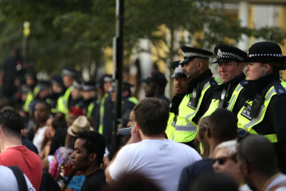 Police watch over the crowds at the Notting Hill Carnival (AFP/Getty Images)