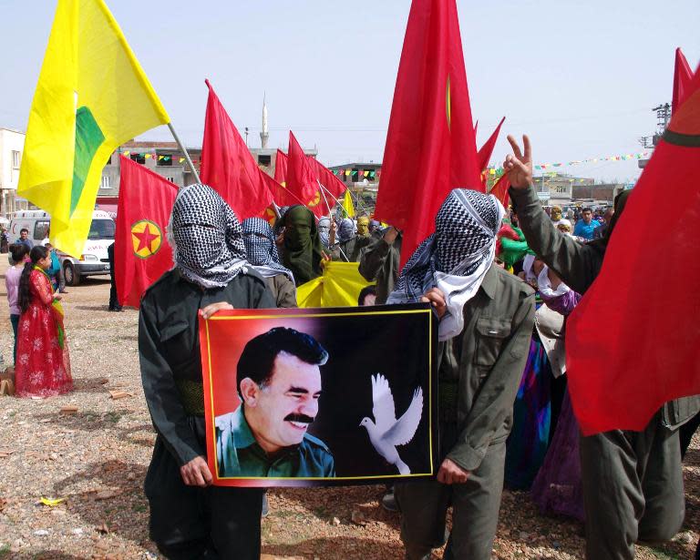 Masked Kurdish people hold a portait of jailed Kurdish rebel chief Abdullah Ocalan during a 2013 ceremony in Urfa, southeastern Turkey