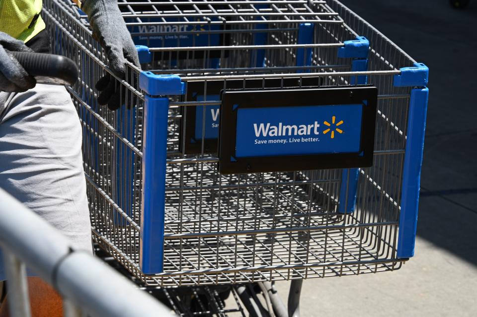 An employee gathers shopping carts at Walmart, July 22, 2020 in Burbank, California. - The country's most populous state reported a record 12,807 new coronavirus infections in the past 24 hours. (Photo by Robyn Beck / AFP) (Photo by ROBYN BECK/AFP via Getty Images)