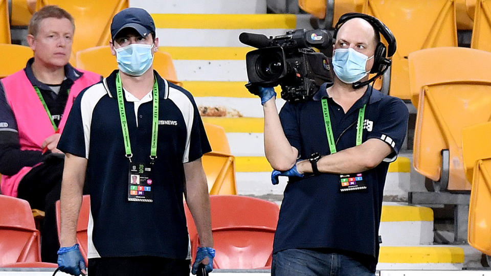 TV cameramen, pictured here wearing masks and gloves due to the COVID-19 restrictions.