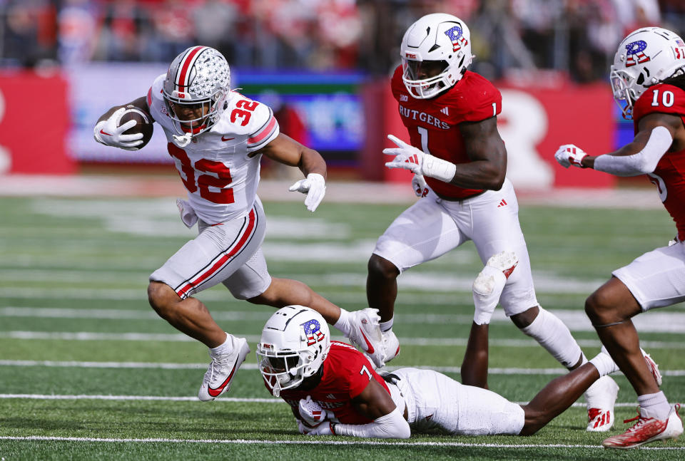 Ohio State running back TreVeyon Henderson (32) rushes against Rutgers defensive back Robert Longerbeam (7) during the first half of a NCAA college football game, Saturday, Nov. 4, 2023, in Piscataway, N.J. (AP Photo/Noah K. Murray)