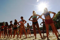 Dancers rehearse their performances for the London 2012 Olympic Beach Volleyball matches at the practice facility near to Horse Guards Parade in London July 24, 2012. (REUTERS/Luke MacGregor)
