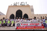 Supporters of Islamic Andolan Bangladesh, an Islamist political party, protest against French President Emmanuel Macron and against the publishing of caricatures of the Prophet Muhammad they deem blasphemous, in front of Baitul Mukarram mosque in Dhaka, Bangladesh, Tuesday, Oct. 27, 2020. Muslims in the Middle East and beyond on Monday called for boycotts of French products and for protests over the caricatures, but Macron has vowed his country will not back down from its secular ideals and defense of free speech. (AP Photo/Mahmud Hossain Opu)