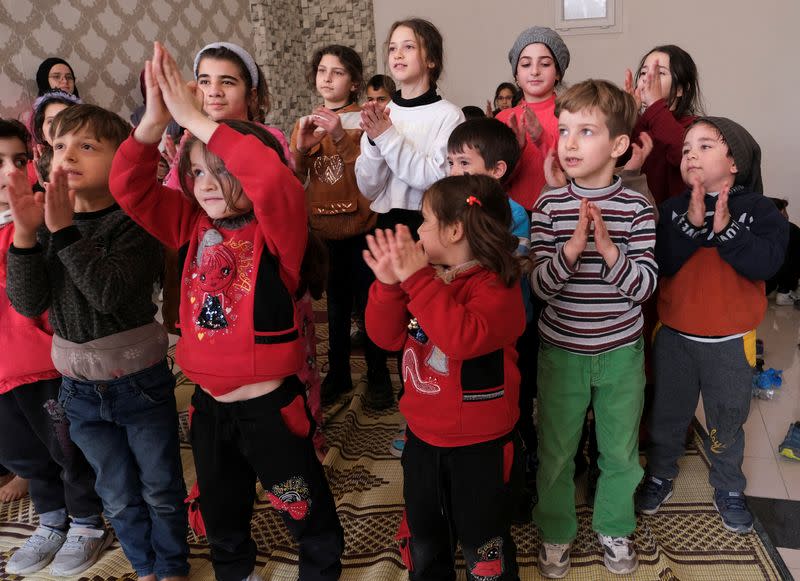 Children play at a makeshift shelter in Mersin