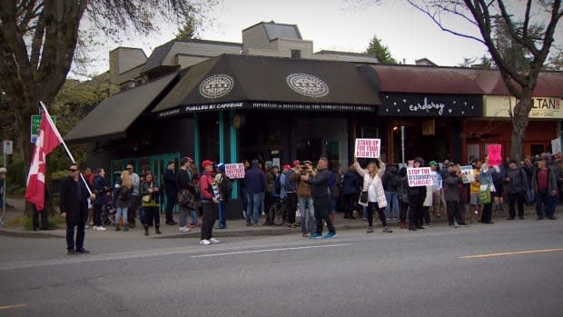 Dozens of people attended the protest in Vancouver's Kitsilano neighbourhood Friday night. 