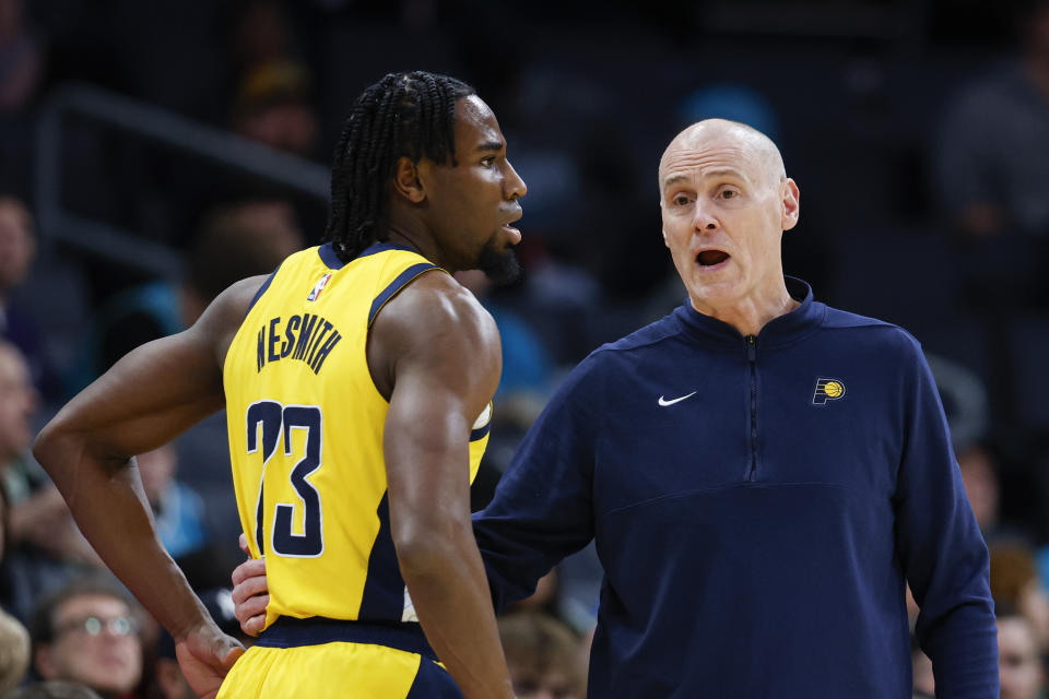 Indiana Pacers head coach Rick Carlisle, right, talks to center Myles Turner, left, during the first half of an NBA basketball game against the Charlotte Hornets in Charlotte, N.C., Monday, Feb. 12, 2024. (AP Photo/Nell Redmond)