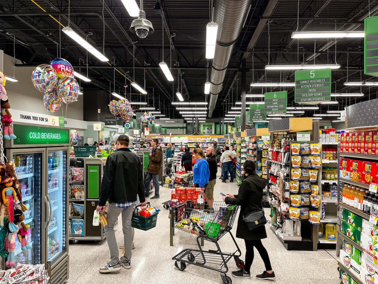 Shoppers wait in line at a store