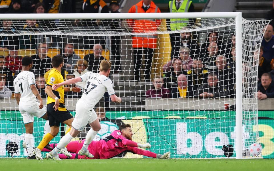 Kevin De Bruyne slides in his fourth goal against Wolves - this time, with his right foot - Getty Images