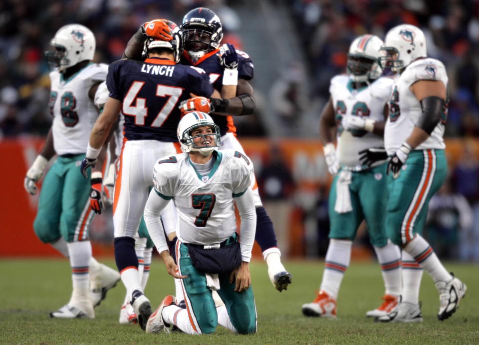 In this 2004 photo, Dolphins' QB A.J. Feeley gets up after being hit by Denver Broncos safety John Lynch in the third quarter.