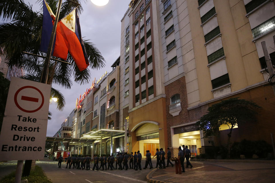 <p>Police walk outside a hotel at the Resorts World Manila complex, early Friday, June 2, 2017, in Manila, Philippines. (Photo: Aaron Favila/AP) </p>