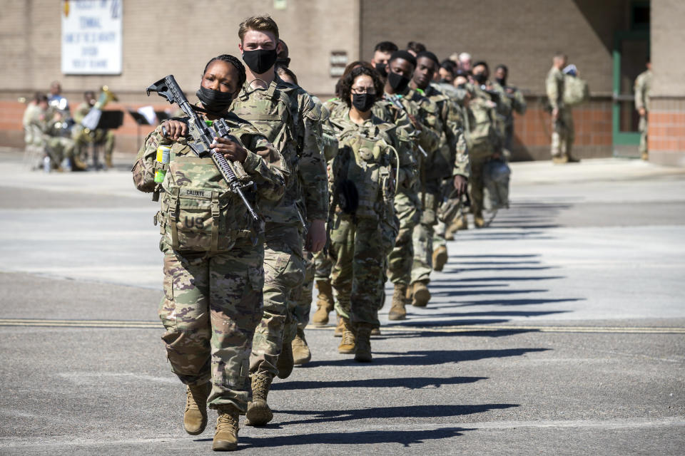 Some of the 180 soldiers with the U.S. Army 3rd Infantry Division, 1st Armored Brigade Combat Team march to a charter airplane at Hunter Army Airfield during their deployment to Germany, Wednesday March 2, 2022 in Savannah, Ga. The division is sending 3,800 troops as reinforcements for various NATO allies in Eastern Europe. (Stephen B. Morton /Atlanta Journal-Constitution via AP)